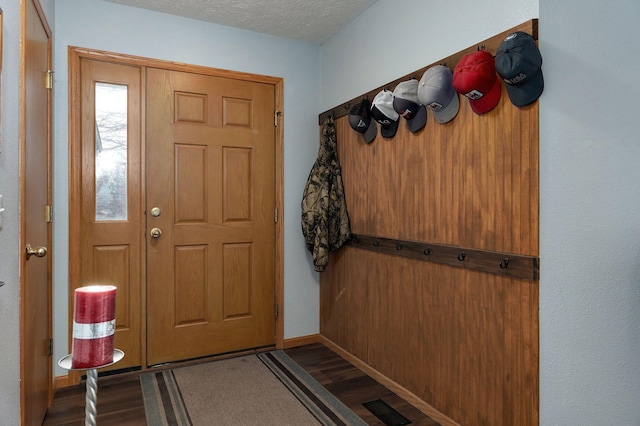 foyer featuring wood-type flooring and a textured ceiling