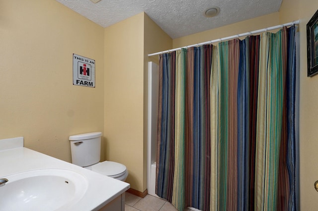 bathroom with tile patterned flooring, vanity, toilet, a textured ceiling, and a shower with shower curtain