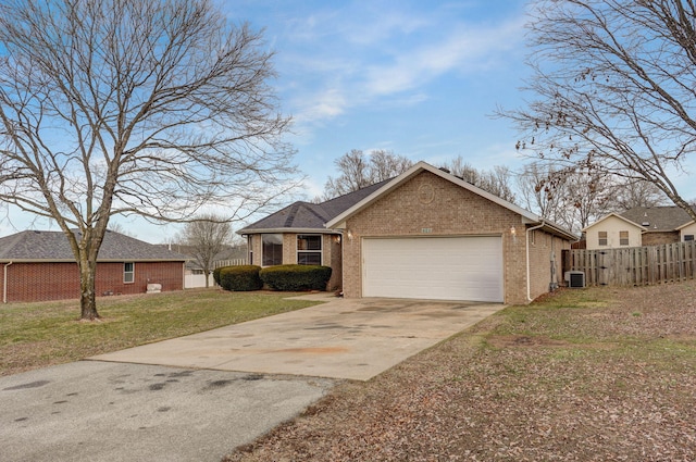 view of front of property featuring a garage, cooling unit, and a front yard