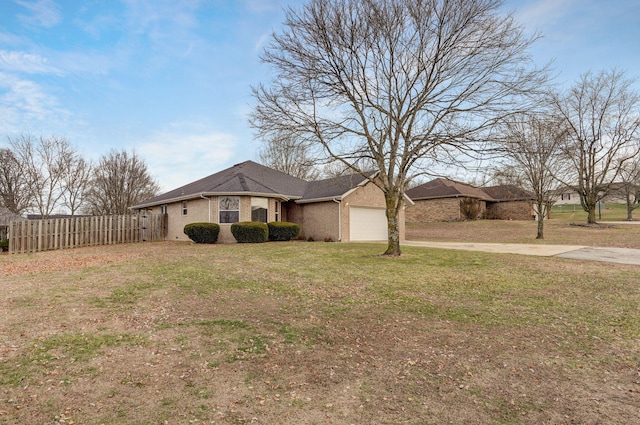 ranch-style home with a garage and a front lawn