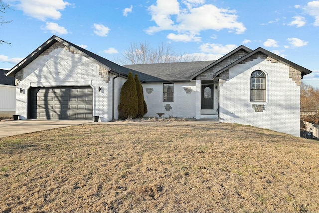 view of front of property with a garage and a front lawn