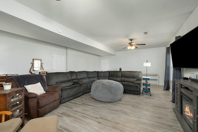 living room featuring light hardwood / wood-style flooring and ceiling fan