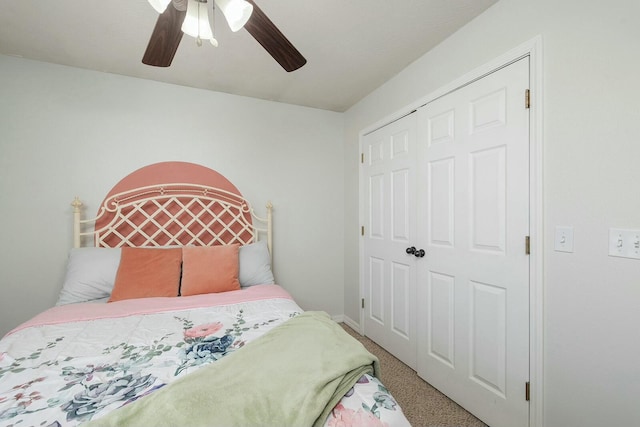 carpeted bedroom with ceiling fan and a closet