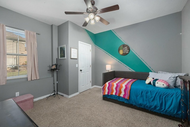 bedroom with multiple windows, ceiling fan, and carpet flooring