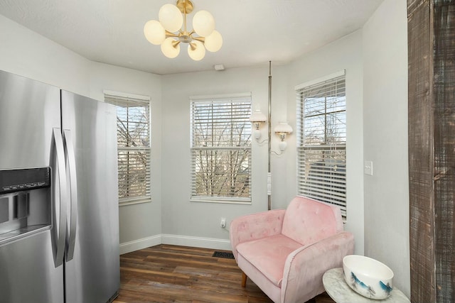 living area with a notable chandelier and dark wood-type flooring