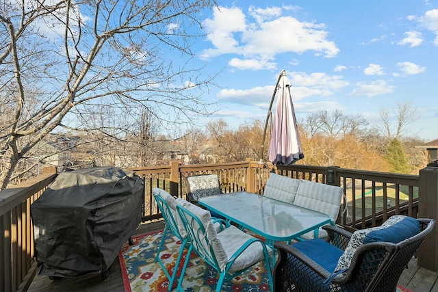 wooden deck with a grill