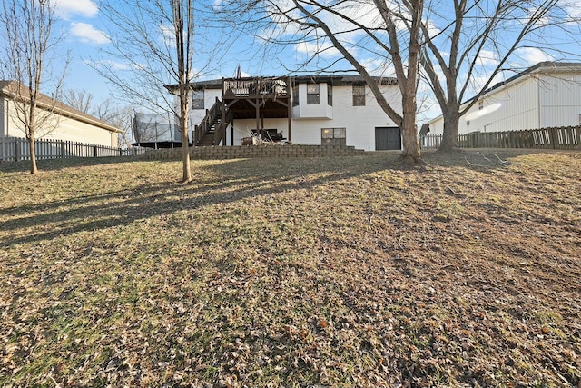 rear view of house featuring a yard and a deck