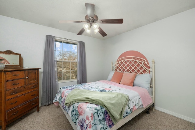 bedroom featuring light carpet and ceiling fan