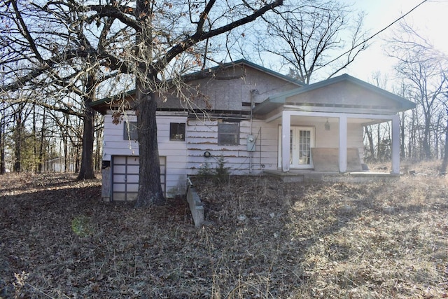 exterior space with a porch and a garage