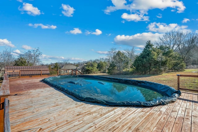 view of swimming pool with a wooden deck