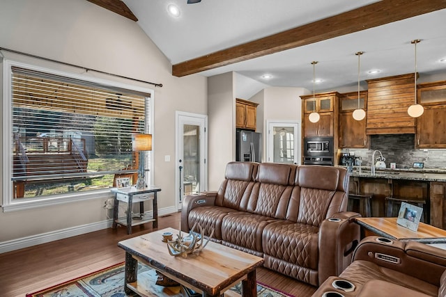 living room featuring sink, lofted ceiling with beams, and dark hardwood / wood-style floors