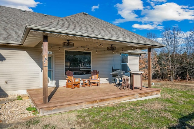 wooden terrace featuring area for grilling and ceiling fan