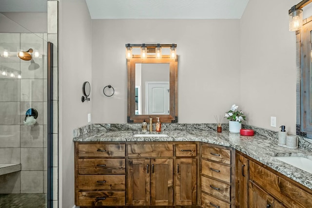 bathroom with walk in shower and vanity