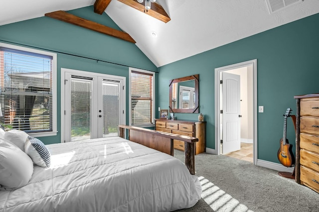 carpeted bedroom featuring multiple windows, vaulted ceiling with beams, french doors, and access to exterior