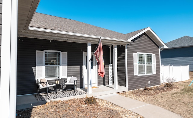 view of exterior entry with a porch