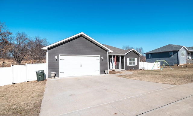 ranch-style house with a garage, a playground, and a front yard