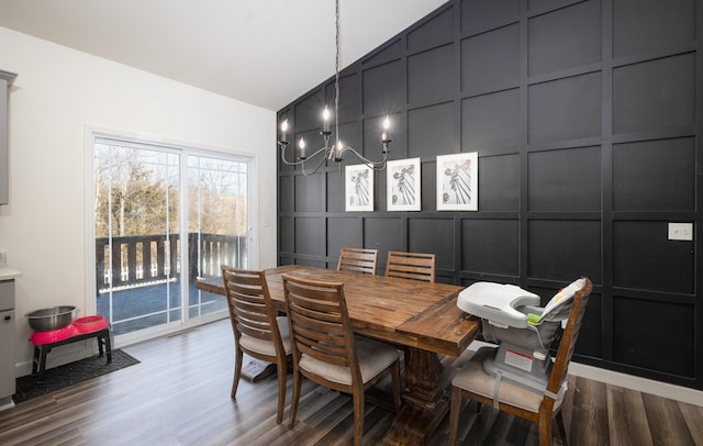 dining area featuring lofted ceiling, a notable chandelier, and wood-type flooring