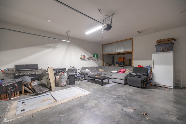 garage with white refrigerator and a garage door opener