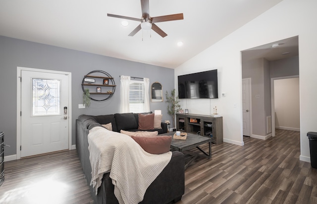 living room with ceiling fan, dark hardwood / wood-style floors, and vaulted ceiling