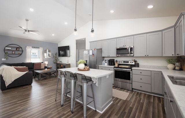 kitchen featuring a kitchen island, appliances with stainless steel finishes, pendant lighting, and gray cabinetry