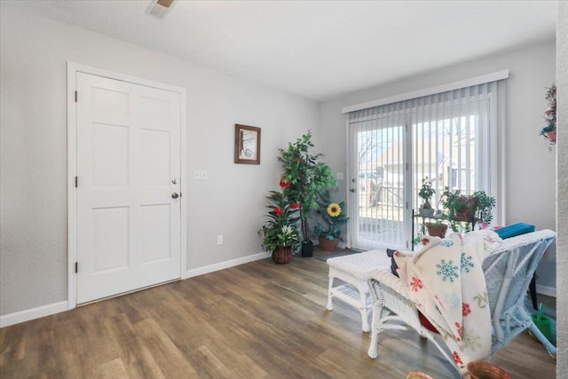 sitting room with dark hardwood / wood-style floors