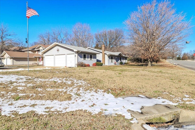 view of front of house with a garage and a lawn