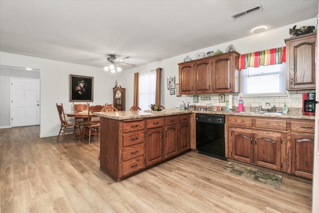 kitchen featuring sink, a textured ceiling, dishwasher, kitchen peninsula, and decorative backsplash