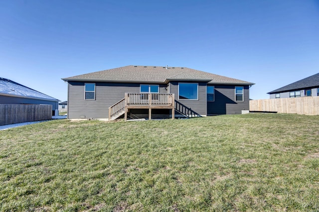 rear view of property featuring a deck and a lawn