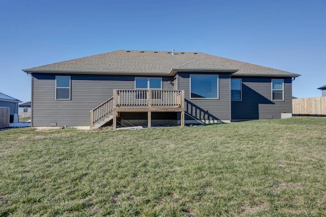 rear view of house with a deck and a lawn