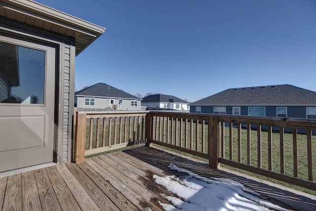 wooden terrace featuring a lawn