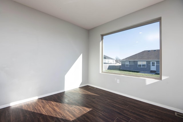 empty room with hardwood / wood-style floors