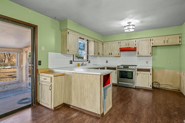 kitchen featuring plenty of natural light, sink, stainless steel range oven, and decorative backsplash