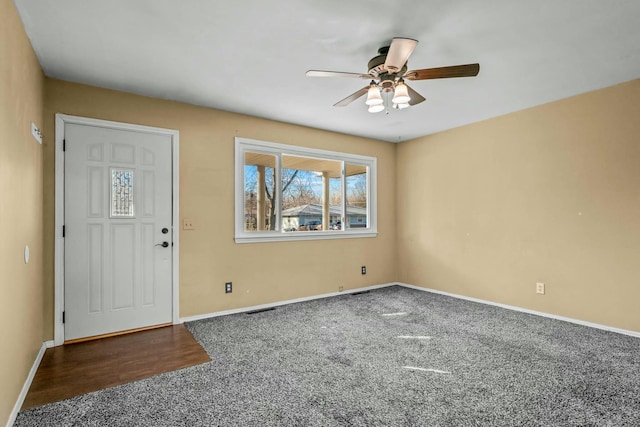 carpeted foyer with ceiling fan