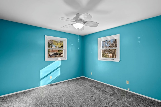 carpeted spare room featuring ceiling fan