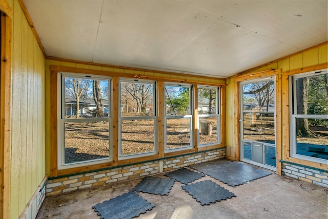 unfurnished sunroom featuring lofted ceiling