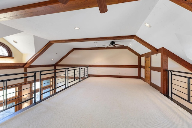 bonus room with carpet floors and vaulted ceiling with beams