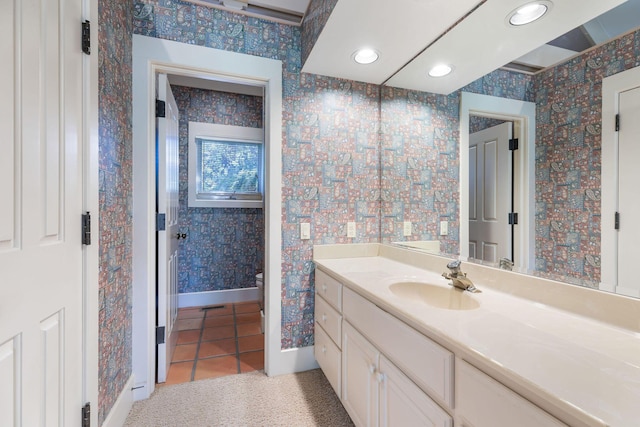 bathroom featuring tile patterned flooring, vanity, and toilet