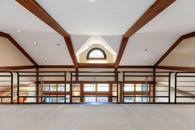 interior space with beamed ceiling and carpet flooring