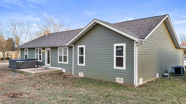 1989 Crawford St, West Plains, MO 65775 - back of house with central AC, a patio area, a hot tub, and a lawn
