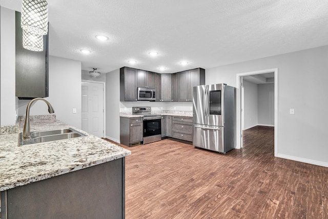 1989 Crawford St, West Plains, MO 65775 - kitchen with sink, dark hardwood / wood-style flooring, light stone counters, stainless steel appliances, and a textured ceiling