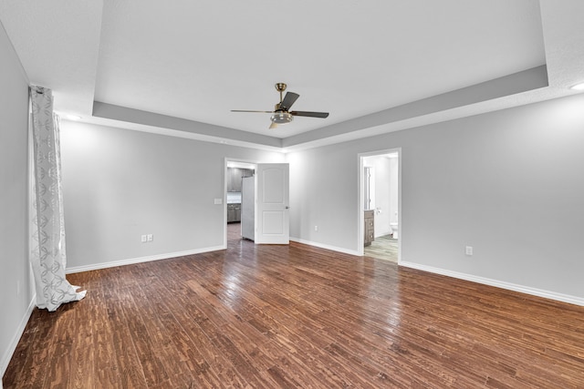 1989 Crawford St, West Plains, MO 65775 - unfurnished bedroom featuring dark wood-type flooring, ceiling fan, and connected bathroom