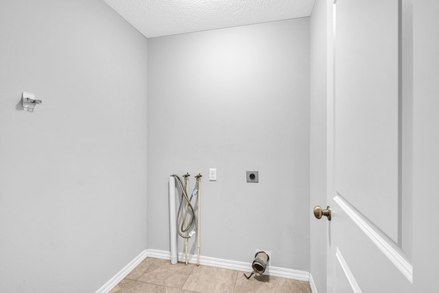 1989 Crawford St, West Plains, MO 65775 - washroom with electric dryer hookup, light tile patterned floors, hookup for a washing machine, and a textured ceiling