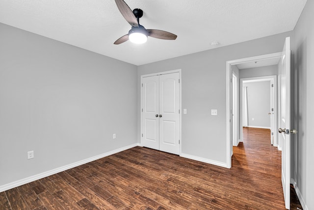 1989 Crawford St, West Plains, MO 65775 - unfurnished bedroom with ceiling fan, dark hardwood / wood-style floors, a closet, and a textured ceiling