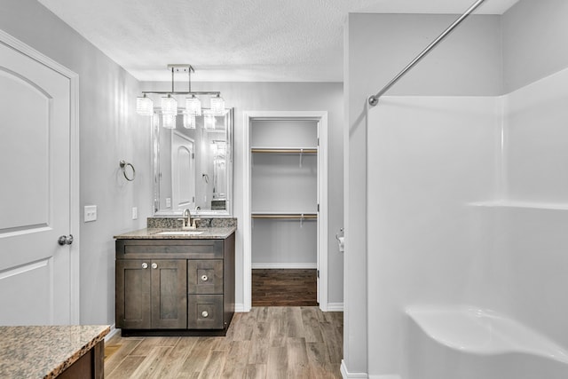 1989 Crawford St, West Plains, MO 65775 - bathroom with vanity, wood-type flooring, and a textured ceiling