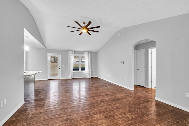 1989 Crawford St, West Plains, MO 65775 - unfurnished living room with dark wood-type flooring, ceiling fan, vaulted ceiling, and a textured ceiling