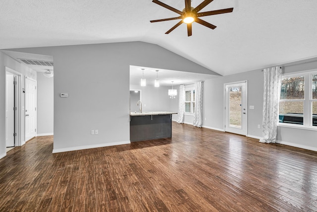1989 Crawford St, West Plains, MO 65775 - unfurnished living room with dark wood-type flooring, ceiling fan, lofted ceiling, and a textured ceiling