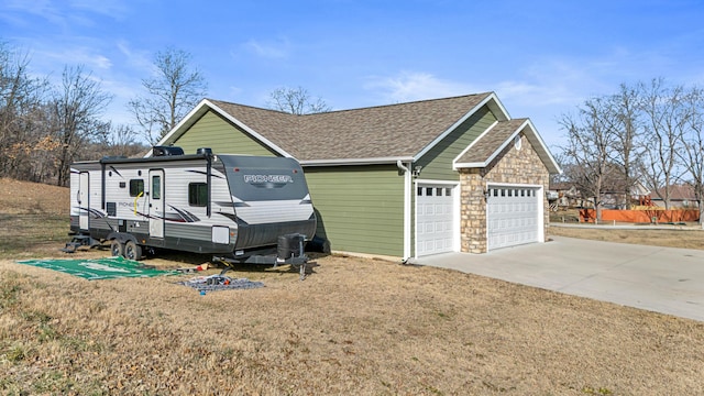 view of home's exterior with a garage and a lawn