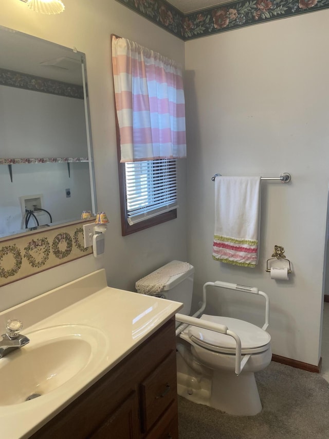 bathroom featuring vanity and toilet