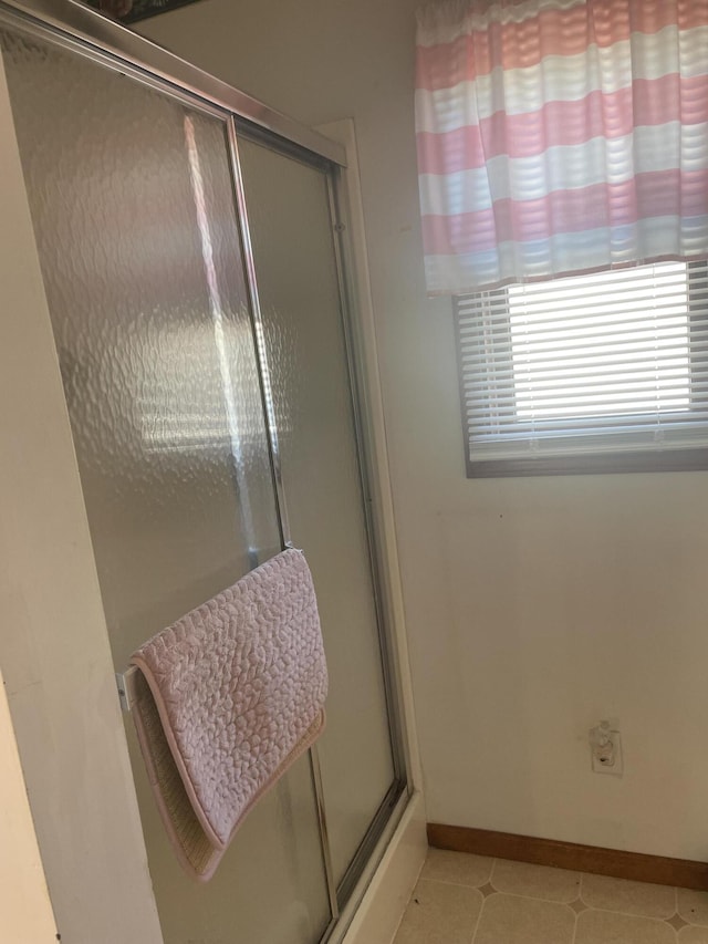 bathroom with a shower with door