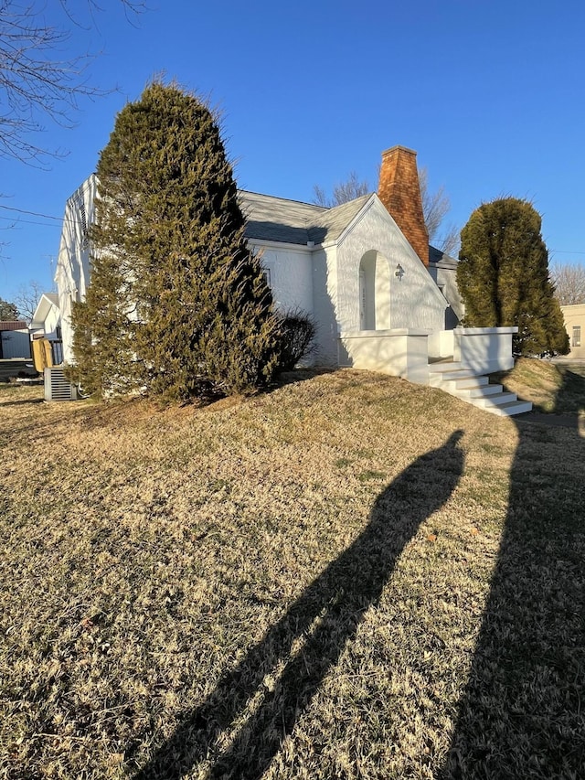 view of property exterior with a yard